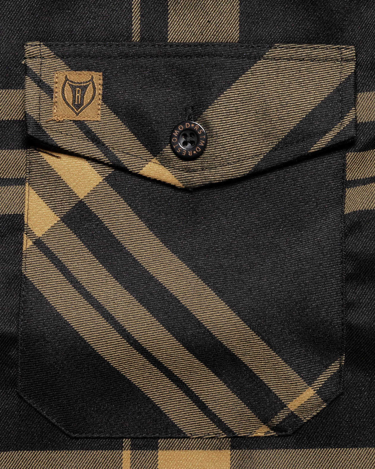 gold and black plaid flannel front pocket view on the two-lane flannel