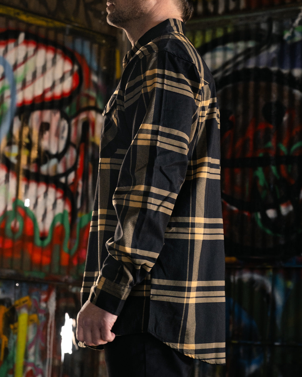 Two-Lane black and gold flannel side view on a model