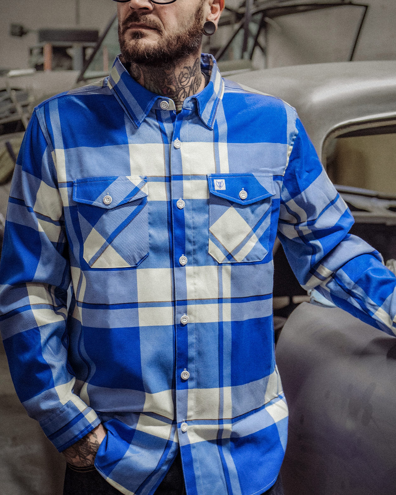 f**kin problems Flannel - a blue and white flannel on a model working with his hands