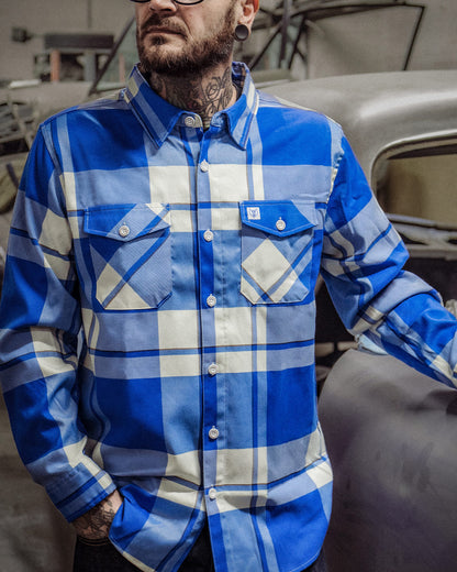 f**kin problems Flannel - a blue and white flannel on a model working with his hands