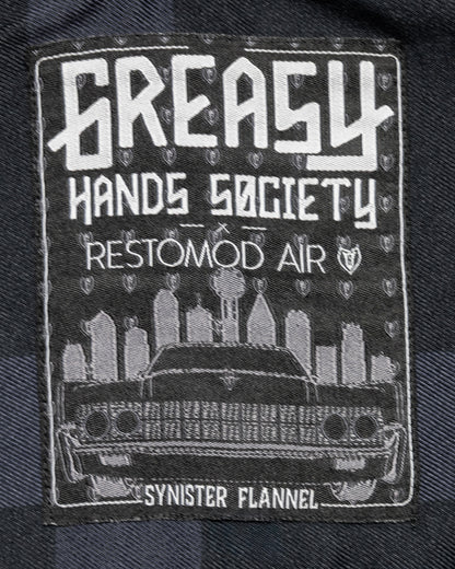 grasy hands society synister flannel label detail showing the dallas skyline and a black lincoln continental