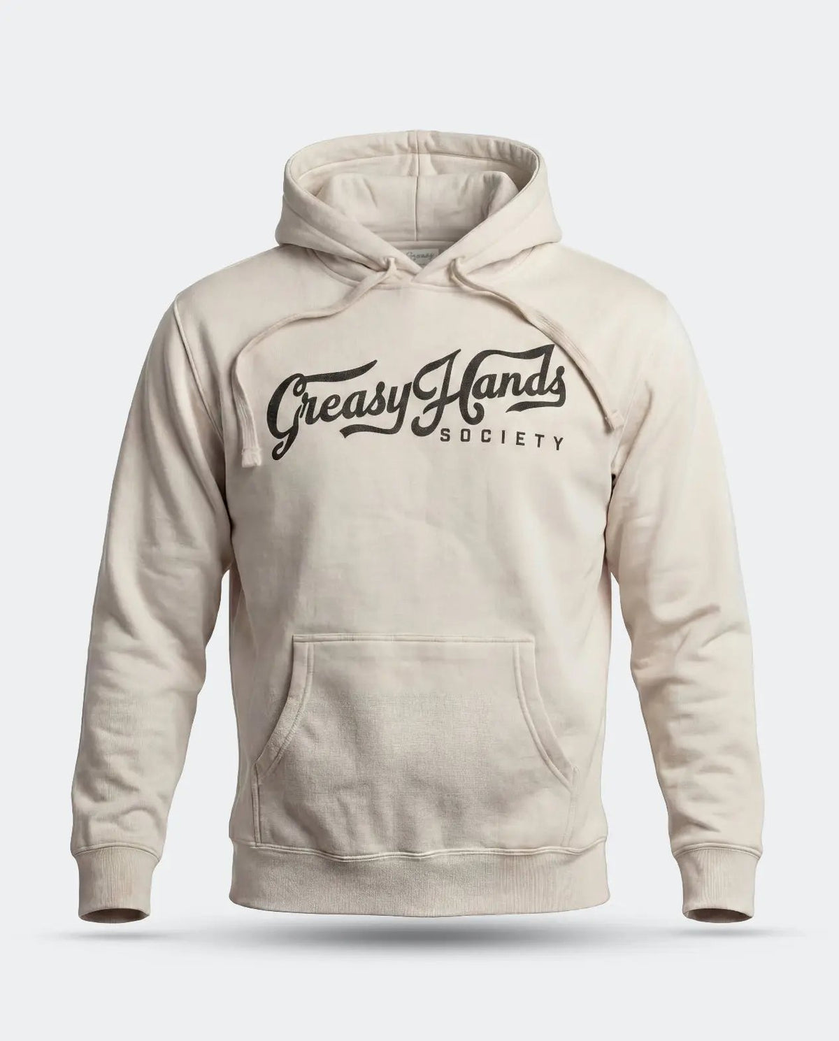 A cream-colored pullover hoodie with a black graphic print reading 'Greasy Hands Society' across the chest, displayed on a clean light gray background - Greasy Hands Society Script Hoodie by Greasy Hands Society
