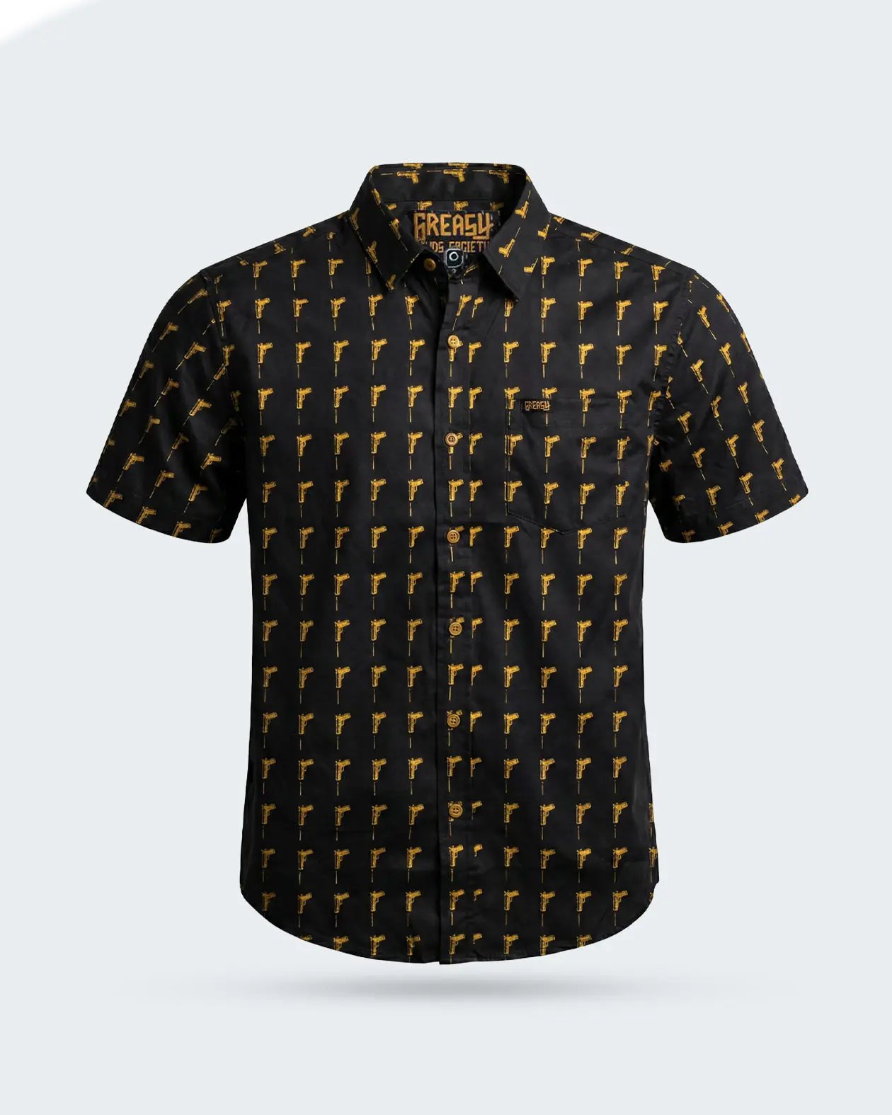 A short-sleeve button-up shirt by The Rebel, featuring a black base with a repeating yellow pistol pattern, displayed on a light gray background - The Hitman Button-Up Shirt by Greasy Hands Society