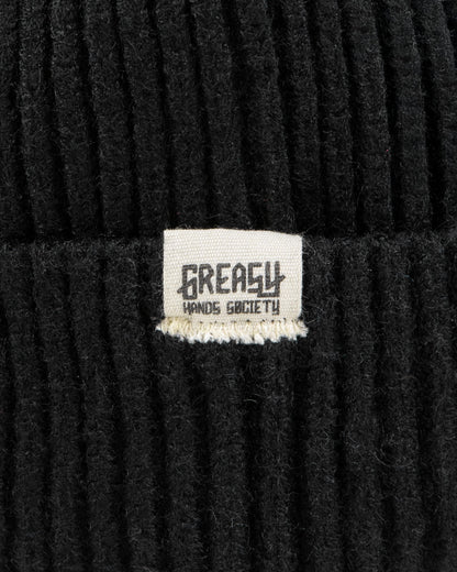 black watch cap detail showing greasy hands society logo tag