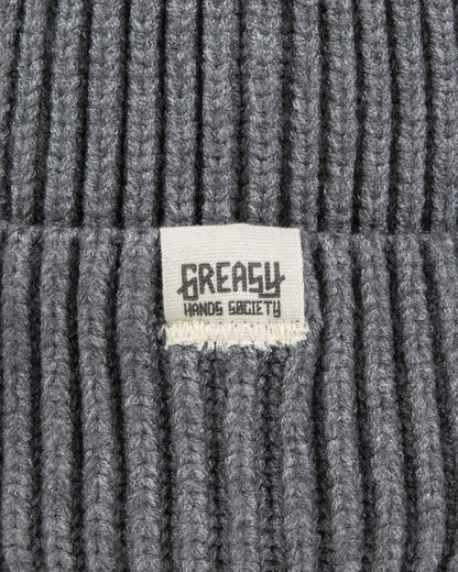 Gray watch cap detail showing the greasy hands society logo tag