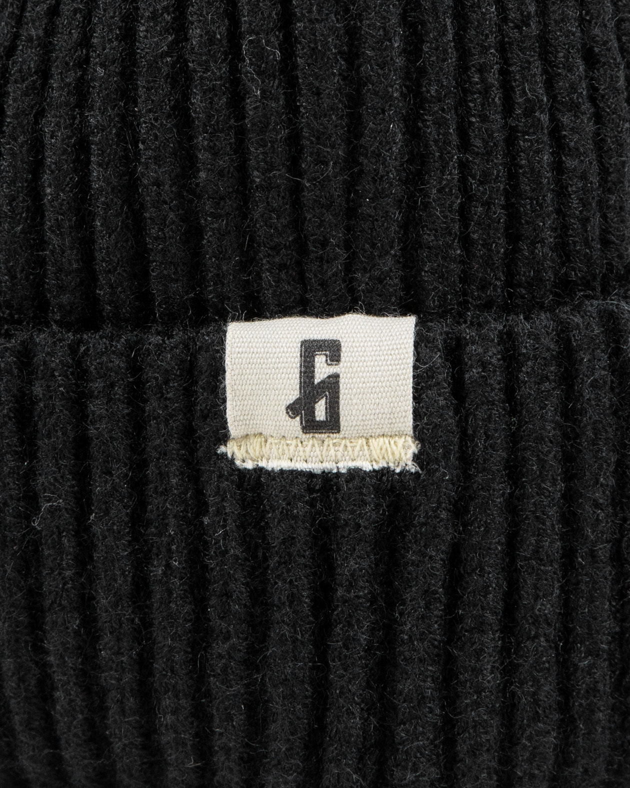 black watch cap tag detail