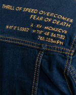 text on the back of the thrill of speed denim jacket