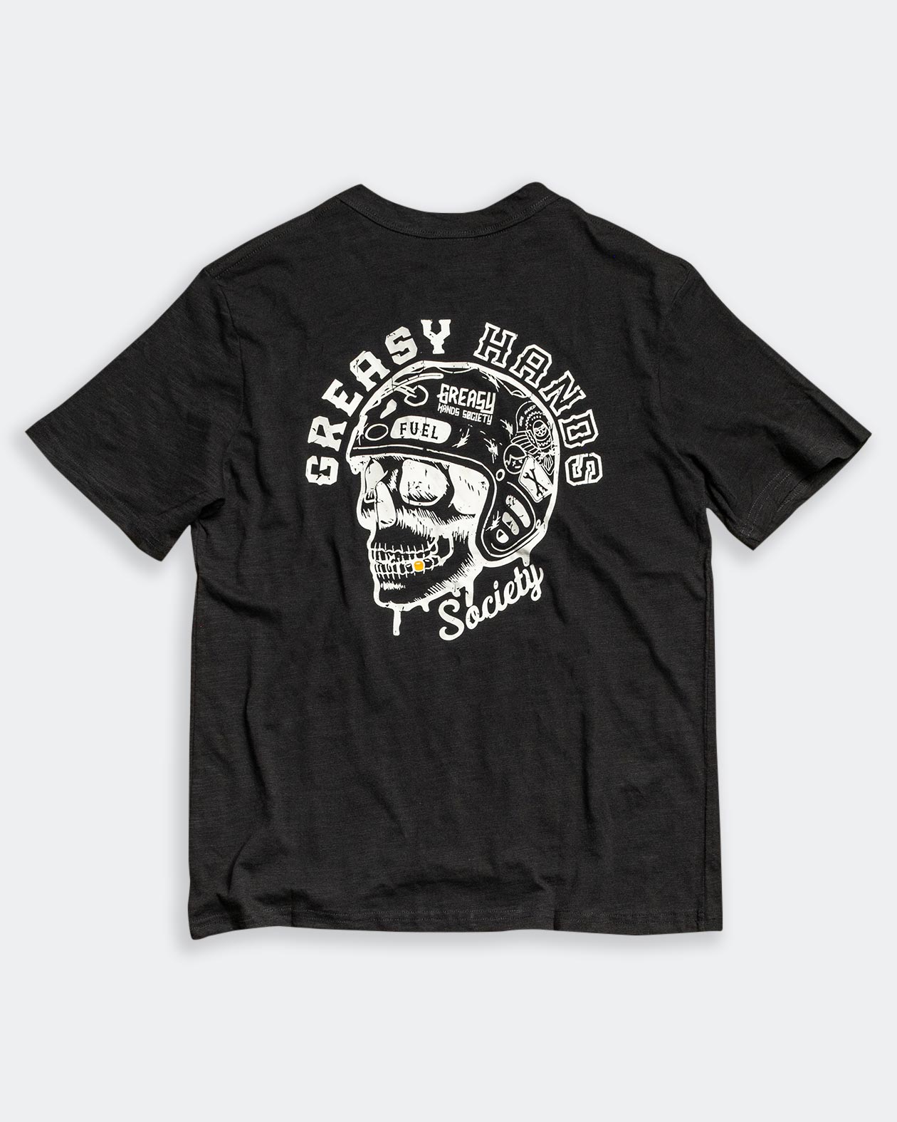 greasy hands society helmet on a skull on a black tshirt back side of a graphic tee