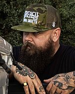 military camo greasy hands society logo hat on a model